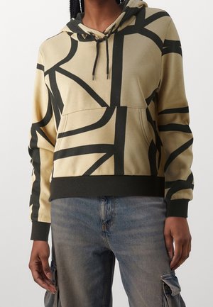 Felpa beige con cappuccio, motivi astratti neri, tasca a marsupio frontale e polsini e orlo a coste. Realizzata in tessuto morbido.