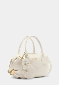 Borsa a mano di colore crema chiaro realizzata in pelle texture, con manici doppi, accessori in tonalità oro e un'etichetta con il marchio. Forma rotonda con chiusura a zip.