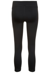 Mustat, hyvin istuvat legginsit, joissa on sileä pinta, keskikorkea vyötärö ja nilkkaan ulottuva pituus, ilman näkyviä logoja tai kuvioita.
