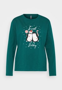 Teal pikkade varrukatega T-särk, mis esitleb kahte karikatuurset pingviini pühade aktsentidega, ümbritsetud valgetsest lumehelvestest ja tekstist "Kena püha".