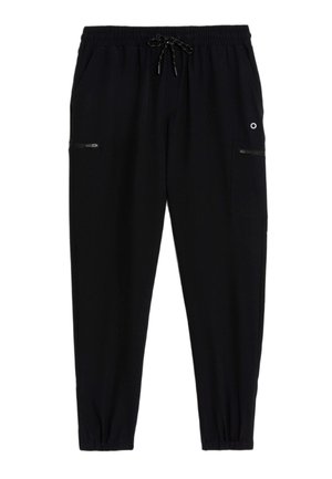 Schwarze Jogginghose aus einem weichen Material, mit elastischem Bund, Kordelzug, Seitentaschen und mit Reißverschluss versehenen Akzenten.