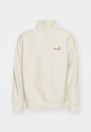 Cream-colored pullover sweatshirt with a high collar, half-zip, and ribbed cuffs. Features a small orange and red logo on the chest.