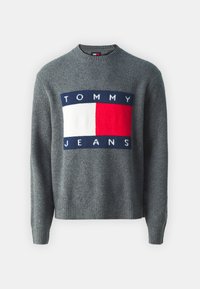 Maglione grigio a maglia con un grande logo composto da rettangoli blu, bianchi e rossi. Polsini e orlo a costine. Design con scollo rotondo.