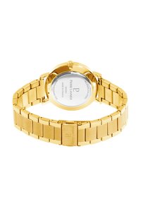 Reloj de acero inoxidable dorado con pulsera de eslabones, caja redonda y fondo de cristal transparente que muestra el nombre de la marca y detalles sobre la resistencia al agua.