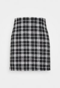 Svart och vit rutmönstrad minikjol i texturerad tyg, med en figurnära design och rak fåll.