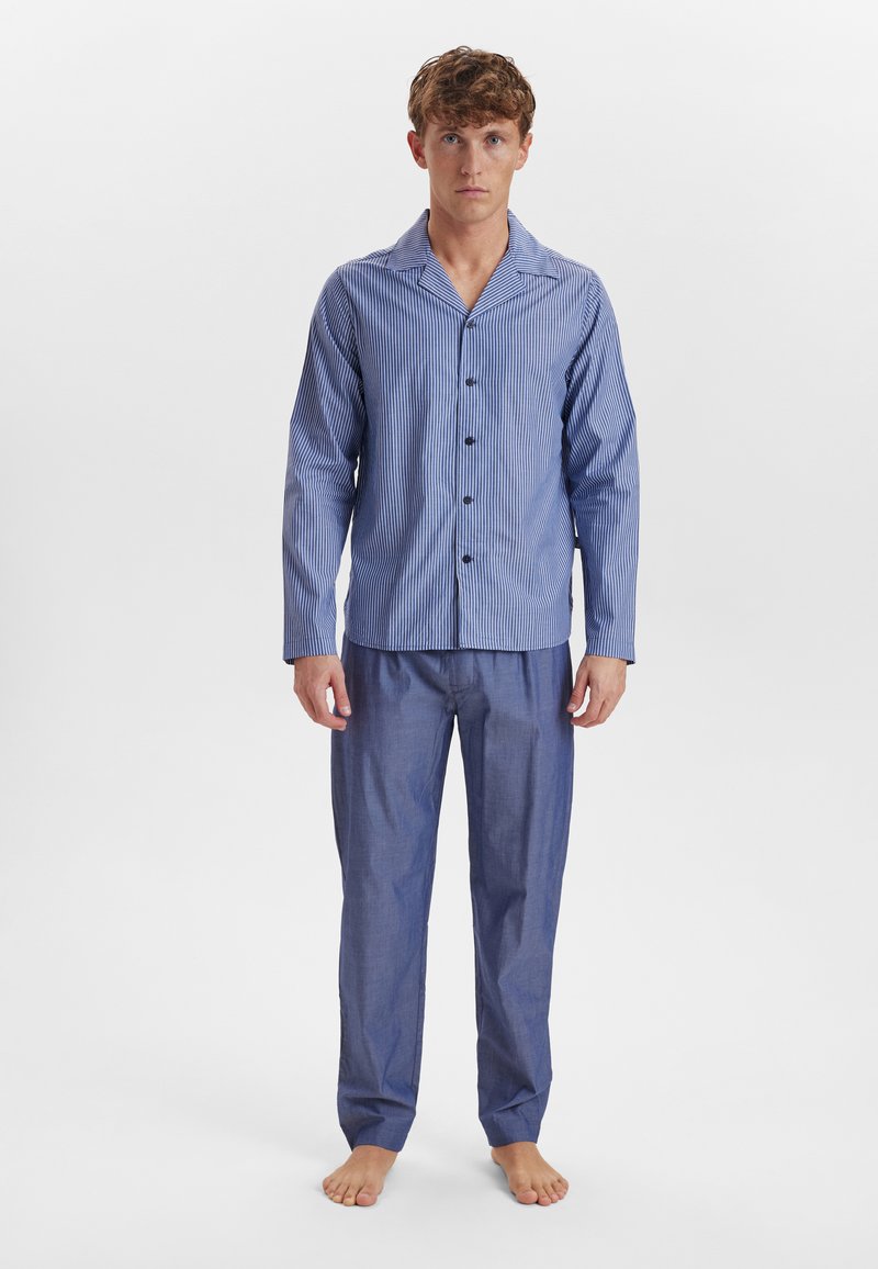Blauw gestreepte pyjama set met een button-up top met een kraag en lange mouwen, gecombineerd met bijpassende losse broek. Van katoen.