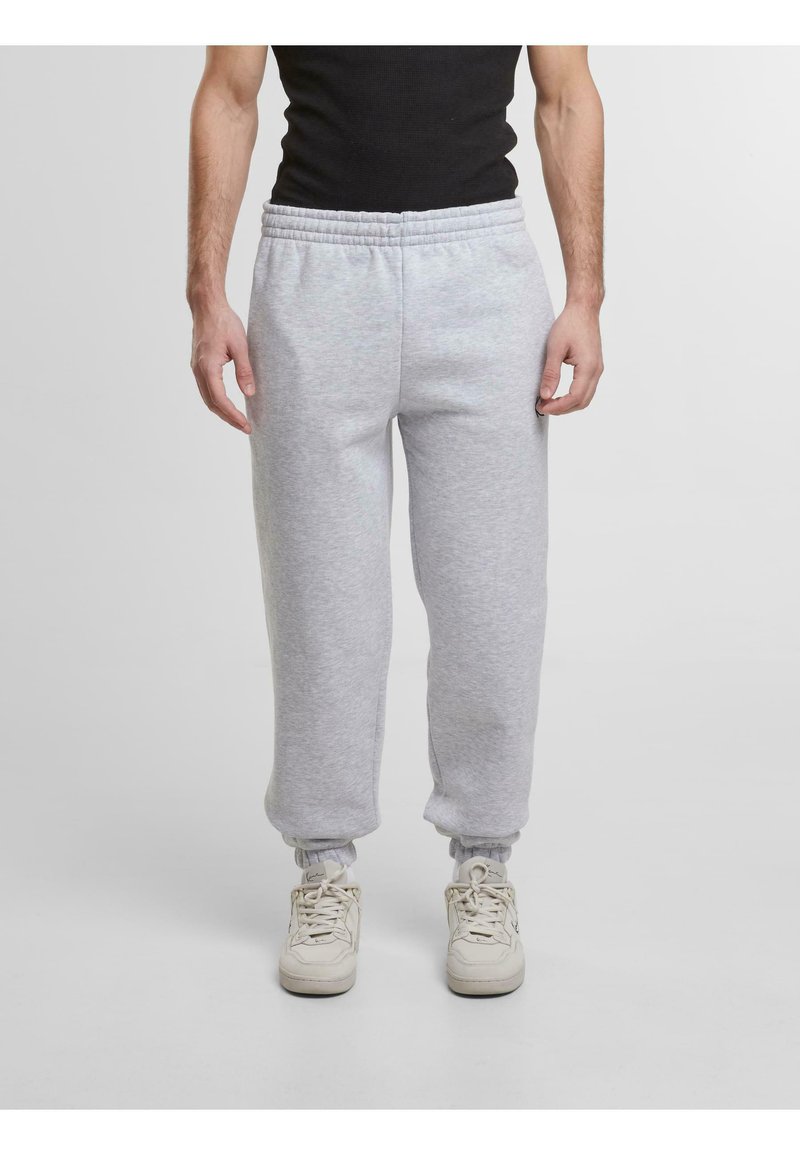 Grijze sweatpants met een elastische tailleband en boorden, met een zachte textuur en een relaxed fit. Gekocht bij lichte sneakers.