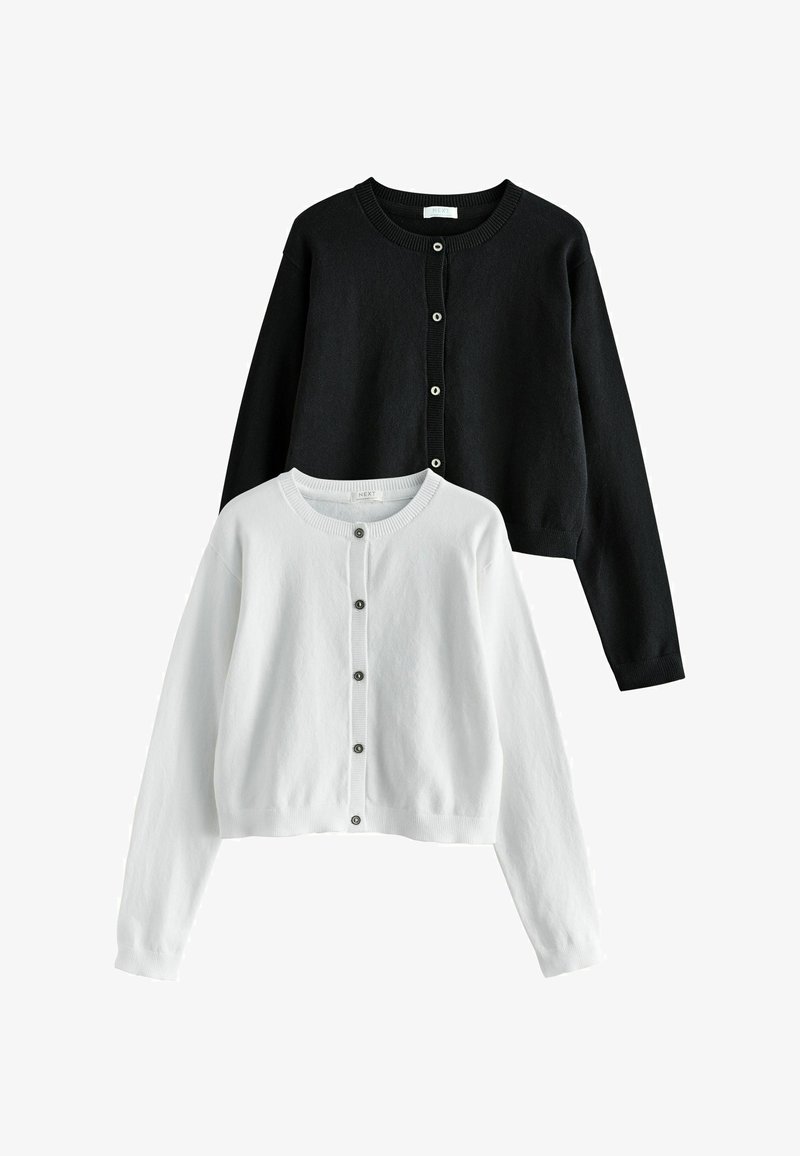Cardigans à manches longues noirs et blancs avec boutons et encolure ronde, présentés à plat avec le cardigan blanc à l'avant.