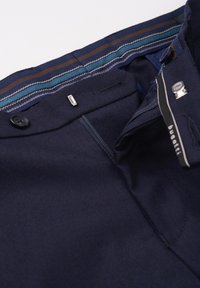 Navy blue trousers with a smooth texture, featuring a striped waistband in blue, brown, and white. Includes a button and zipper closure.