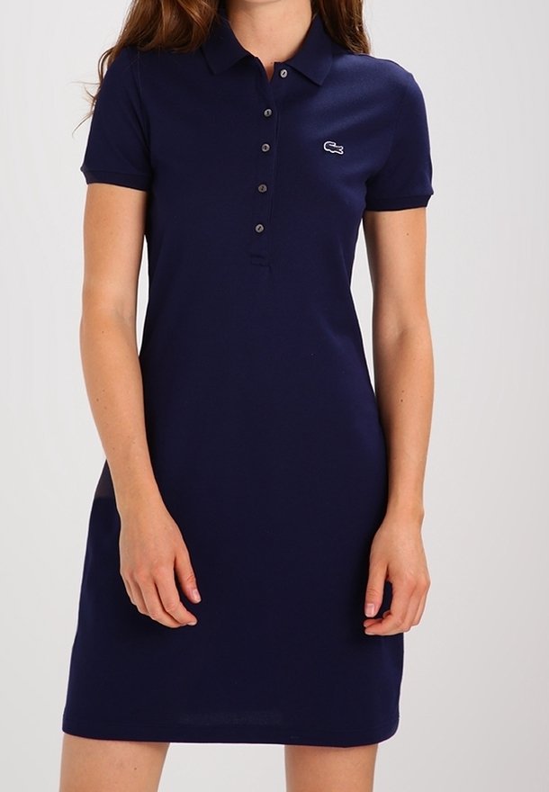 Navy polo dress made of cotton, featuring a collared neckline, button placket, and a small embroidered logo on the left chest.