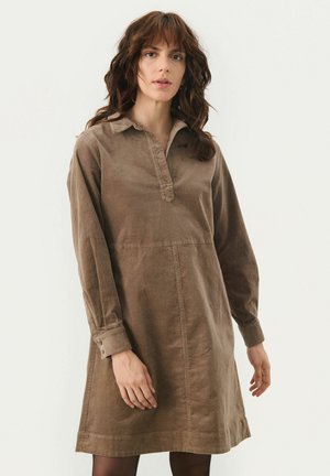 Brown corduroy dress with a collared neckline, long sleeves, and a knee-length hem. Features a buttoned placket and a relaxed fit.