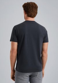 Camiseta de algodón azul marino con mangas cortas y cuello redondo, que presenta una textura suave y un corte relajado en la parte de atrás.