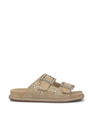 Flat sandal in beige suede featuring cut-out patterns, dual adjustable straps with decorative buckles, and beaded edge detailing.