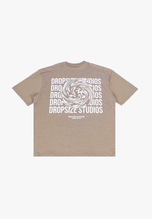 Beige cotton t-shirt featuring a circular graphic with swirling patterns and repeated text "DROPSIZE STUDIOS" in white. Short sleeves, relaxed fit.