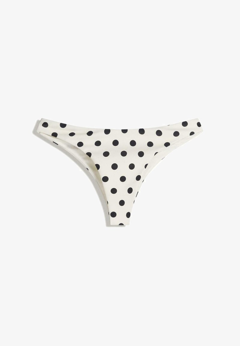 White bikini bottom with black polka dots, featuring a low-rise design and minimal coverage. Made of smooth, stretchy fabric for comfort.