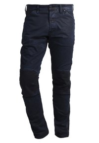 Mörkblå slim-fit byxor med förstärkta knäveck och framfickor, designade för avslappnad eller utomhusbruk.