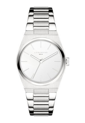 Sølv rustfrit stål ur med et minimalistisk oktogonalt urkasse, hvid skive, sølv timeindekser og et led-armbånd.