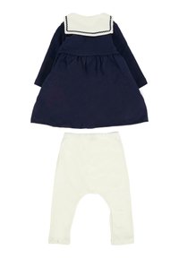 Marineblauwe babyjurk met lange mouwen, witte zeeman-kraag en gegolfde afwerking, gecombineerd met witte babyleggingen met elastische taille.