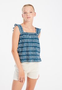 Mėlynos spalvos raštuota palaidinė su baltomis vertikaliomis juostelėmis, kvadratinis iškirpimas ir raukiniai petnešėlėse, derinama su šviesiais šortais. Švelni tekstūra.