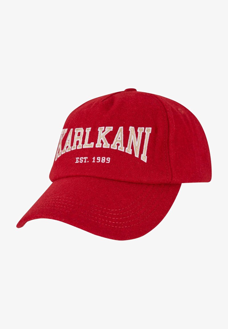Red cotton baseball cap with embroidered "KARL KANI" text and "EST. 1989" on the front. Curved visor and six-panel structure.
