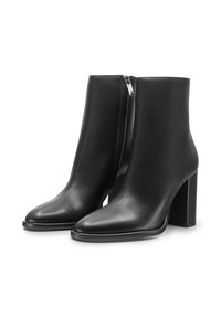 Stivali ankle in pelle nera con punta affusolata e tacco alto chunky. Presentano una cerniera laterale e una texture liscia. Design semplice ed elegante.