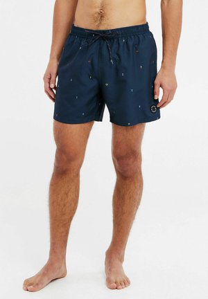 Marineblaue Badeshorts aus leichtem Material, mit einem Kordelzugbund und einem bunten geometrischen Druck im ganzen Design. Mit einem seitlichen Logo-Patch.