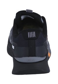 K-Swiss athletic shoes, featuring a black mesh upper, grey accents, a textured sole, and a pull tab at the heel for easy wear.