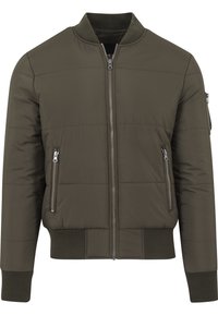 Zelená prešívaná bomber bunda so zipsom vpredu, dvoma bočnými vreckami so zipsom, rebrovanými manžetami, golierom a pásom.