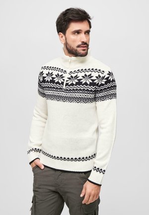 Jersey de cuello con cremallera en crema con patrones de copos de nieve y diamantes en negro, mangas largas y puños y dobladillo acanalados.