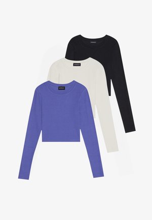 Kollektsioon kolmest lühendatud pika varrukaga T-särgist värvides lilla, valge ja must. Valmistatud pehmest kangast, millel on ribikoe tekstuur ja ümmargune kaelus.