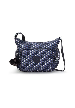 Sac bandoulière à motifs bleu et noir avec poches zippées devant et sur les côtés et un petit porte-clés en peluche noire accroché à la fermeture éclair latérale.