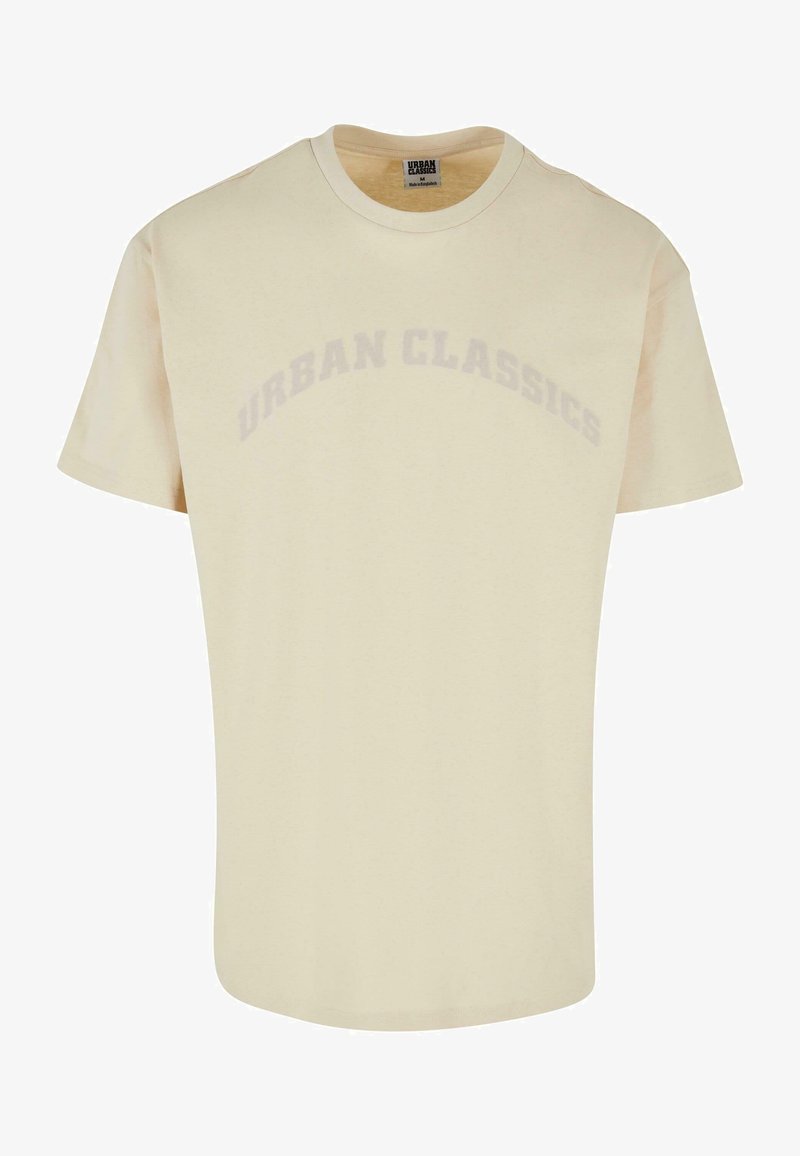 Gaiši beidzis īsām piedurknēm T-krekls, izgatavots no mīksta auduma. Uz krūškurvja pazīstams "URBAN CLASSICS" uzraksts, izdrukāts vieglā arku formā.