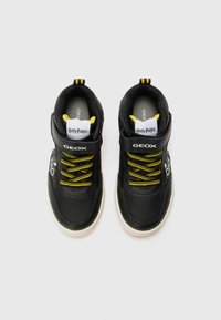 Black Geox sneakers with yellow laces and accents, featuring a textured upper, padded collar, and adjustable strap. Harry Potter branding included.