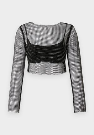 Fekete halhálós crop top hosszú ujjakkal, halhálós mintával és fekete alsó réteggel. Az élek nyers és kissé bolyhos hatásúak.