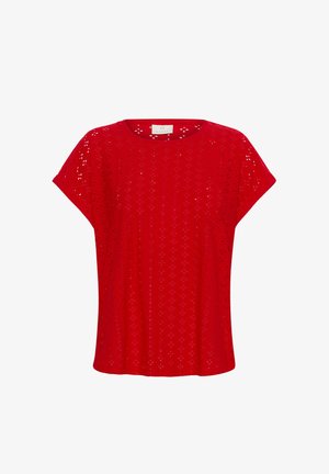 Punainen lyhythihainen paita, jossa on perforoitu kuvio, kevyt kangas ja rento istuvuus, jossa on pyöreä kaula-aukko.