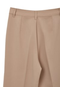 Pantalon beige avec une finition lisse et texturée ; doté de deux plis avant et de passants de ceinture. Fabriqué en tissu léger et respirant.