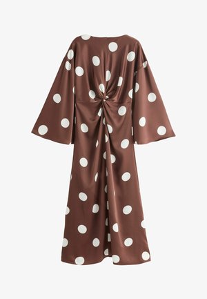 Robe marron à gros pois blancs, manches longues larges et un détail de nœud torsadé à la taille au dos.