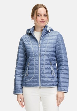 Light blue quilted jacket with a hood, featuring two front zippered pockets and contrasting stitching details for added texture.