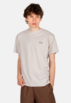 Light gray cotton t-shirt with a round neckline and short sleeves, featuring a small embroidered bicycle and peace symbol on the chest.