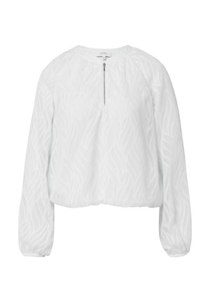 Weiße Bluse mit langen, puffartigen Ärmeln, die ein strukturiertes Blattmuster aufweist und einen halben Reißverschluss am Ausschnitt hat. Weicher, leichter Stoff.