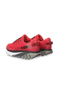 Baskets de sport rouges avec une tige texturée, des lacets noirs et un talon renforcé. Présentent une semelle extérieure blanche et grise contrastante avec un détail de pivot.