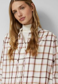 Lange mouwen geruit overhemd in wit met bruine en roze vierkanten, voorzien van een knopenlijst en zacht katoenmateriaal. Details met gerimpelde kraag.