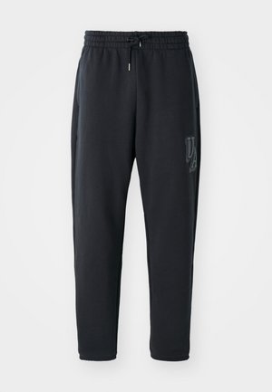 Mørkegrå sweatpants lavet af blødt stof, med en elastisk talje med snørre, sidelommer og et diskret logo foran.
