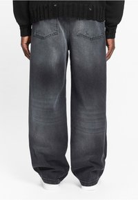 Dark gray, loose-fitting denim jeans with a faded look, featuring two back pockets and a straight leg design.
