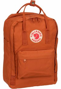 Orange Fjällräven Kanken backpack with reinforced stitching, zipper closure, front pocket, and a circular logo patch in the center.