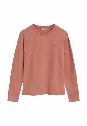 Långärmad t-shirt i mjuk bomull i dämpad rosa, med rund halsringning och en liten broderad logo på bröstet. Rak fåll.