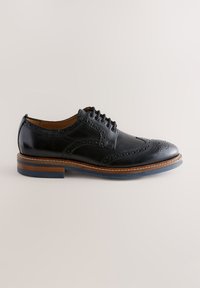 Black leather dress shoe with brogue detailing, rounded toe, lace-up design, and a blue rubber sole with a wooden accent.