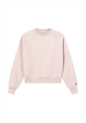 Sweatshirt rose clair avec un col et des poignets côtelés, doté d'une coupe légèrement raccourcie et d'un petit logo sur la poitrine. Les tissus semblent lisses.