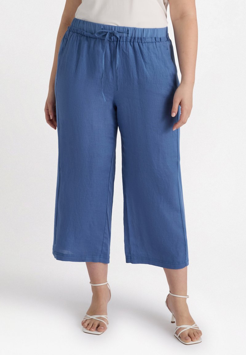 Pantalons courts bleus en tissu léger, avec une taille élastique dotée d'un cordon de serrage et une coupe ample et décontractée.