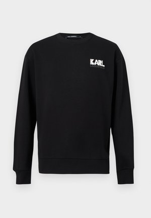 Czarna bluza z długim rękawem i okrągłym dekoltem, z logo "KARL LAGERFELD" w kolorze białym i szarym na lewej górnej części klatki piersiowej.